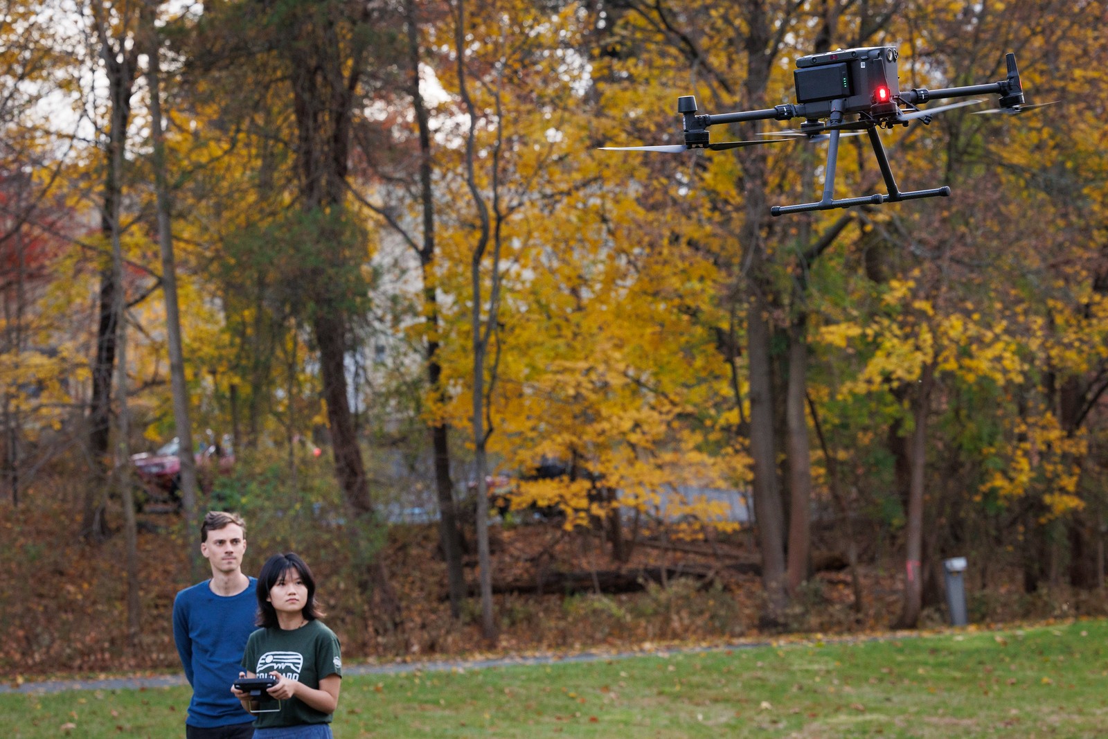 Andrew and Yuwei measure methane using sensors on a drone.
