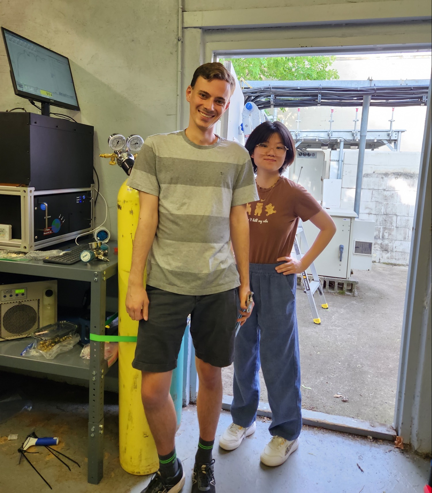 Yuwei and Andrew standing in front of the QCLS instrument at the Mineola tower during FROG-NY